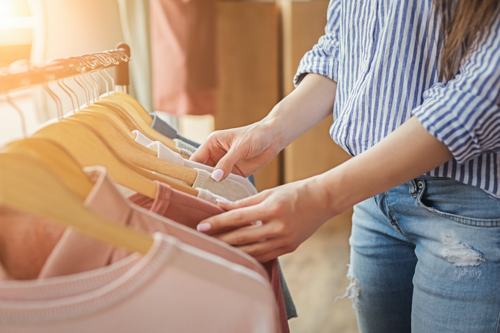 Smiling girl bying clothes in showroom